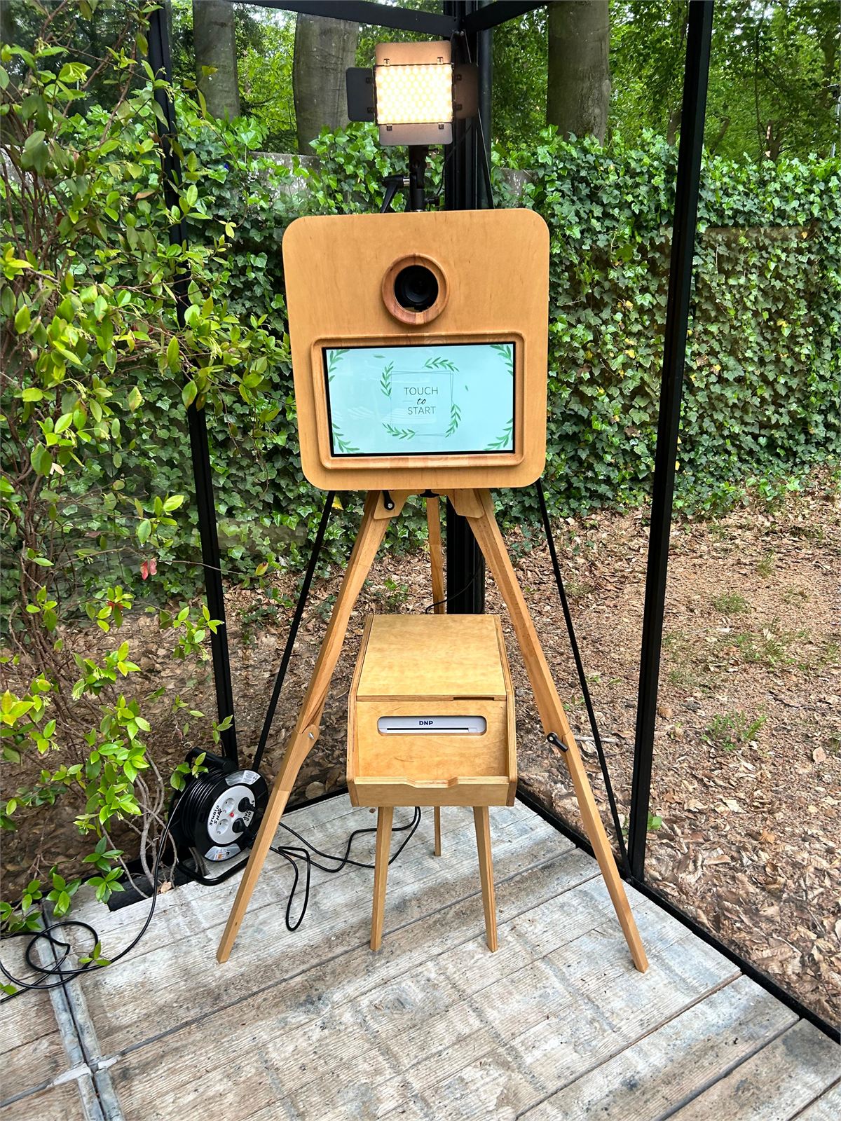 Houten photobooth buiten in een tuin
